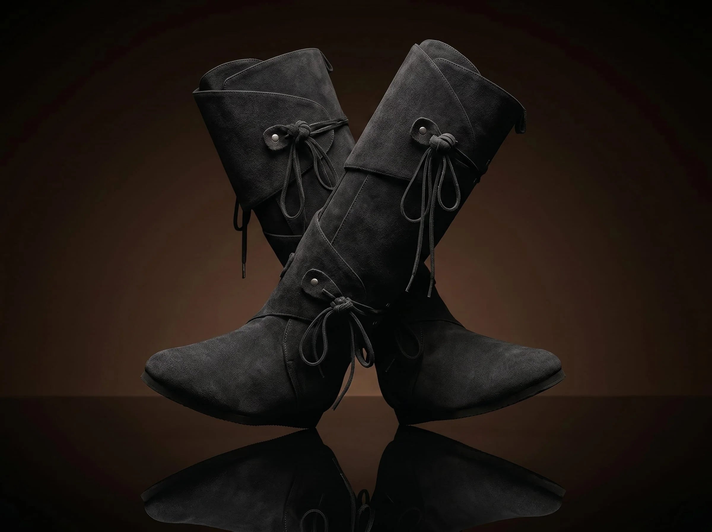 Dual wrap-and-tie strap closure on black suede Noirtide Renaissance boot — metal rivet anchors, genuine suede leather