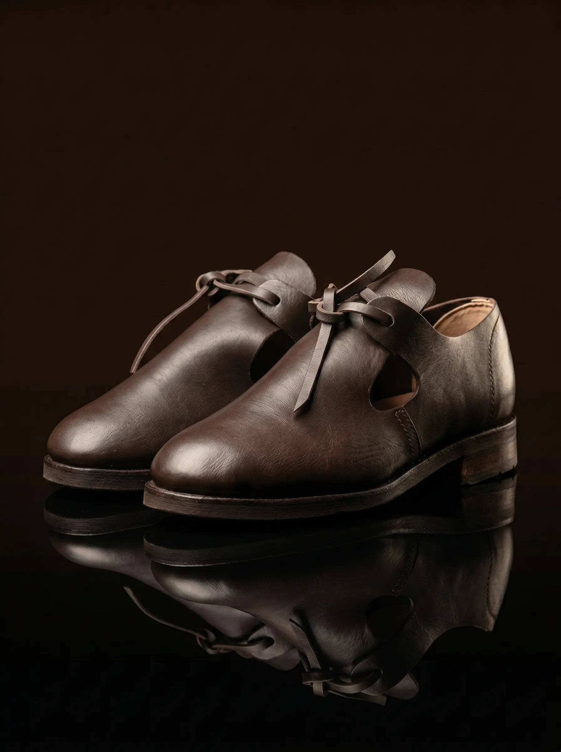 Pair of dark brown handmade open latchet shoes — bespoke 17th century reproduction footwear by Noirtide