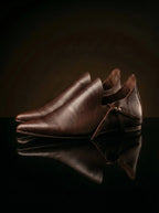 Medieval reenactor wearing dark brown Noirtide poulaine shoes in 15th century noble costume at a living history event